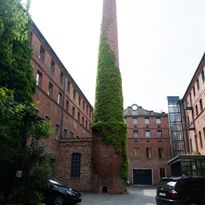 View of inner courtyard restaurant to the factory with ivy-covered factory tower