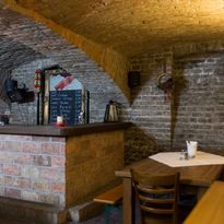 Guest room in the cellar vault of the restaurant with brick walls
